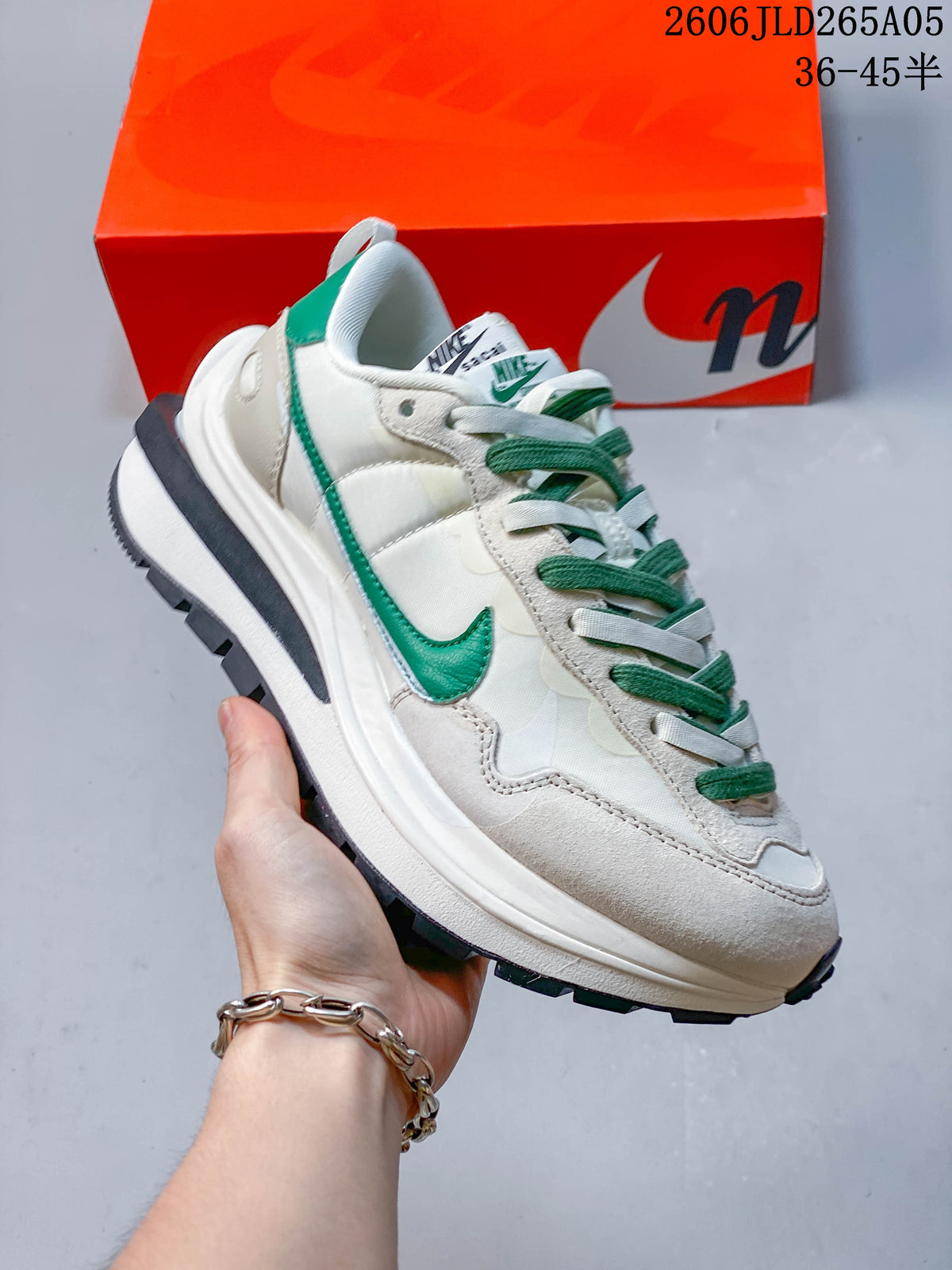 Angled side view of the off-white and green Nike x sacai LDWaffle sneaker.