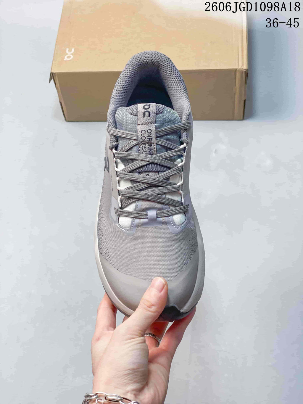 Top view of the gray sneaker showing its laces, tongue, and padded collar.
