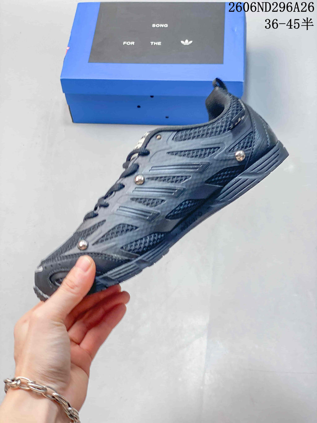 Side profile showing mesh panels, layered overlays and metallic-tone details
