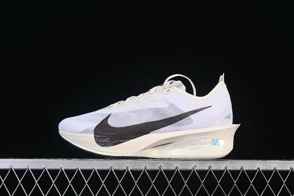 Side view of the white shoe with black Swoosh and sculpted sole