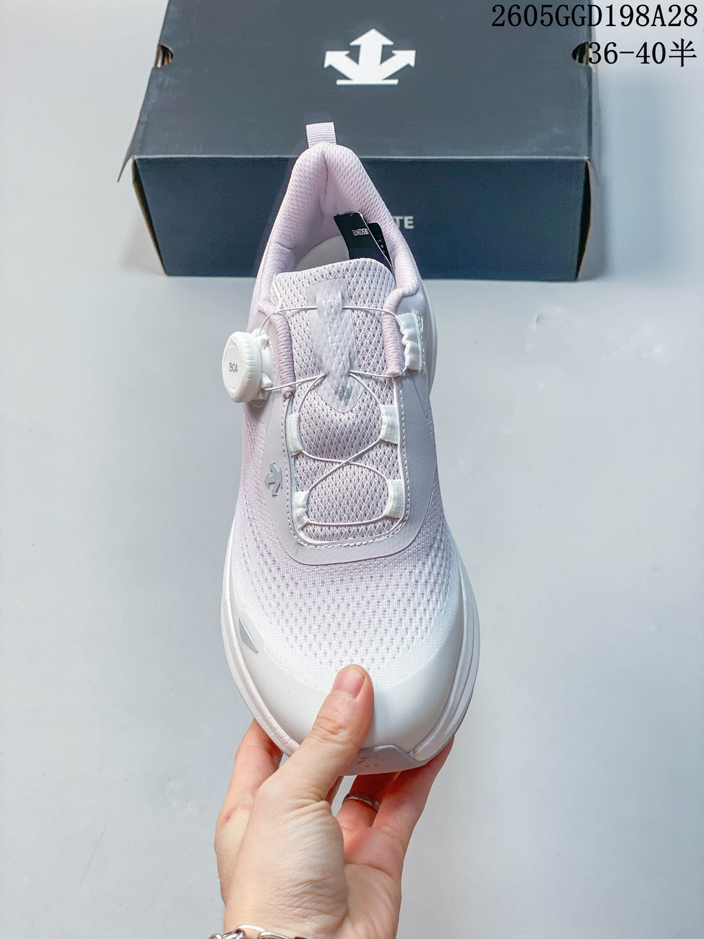 Front view showing the knit-look upper and BOA dial closure of a DESCENTE shoe.