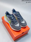 Pair of gray Nike Air Zoom Vomero 17 running shoes with bright lime accents on an orange shoe box.