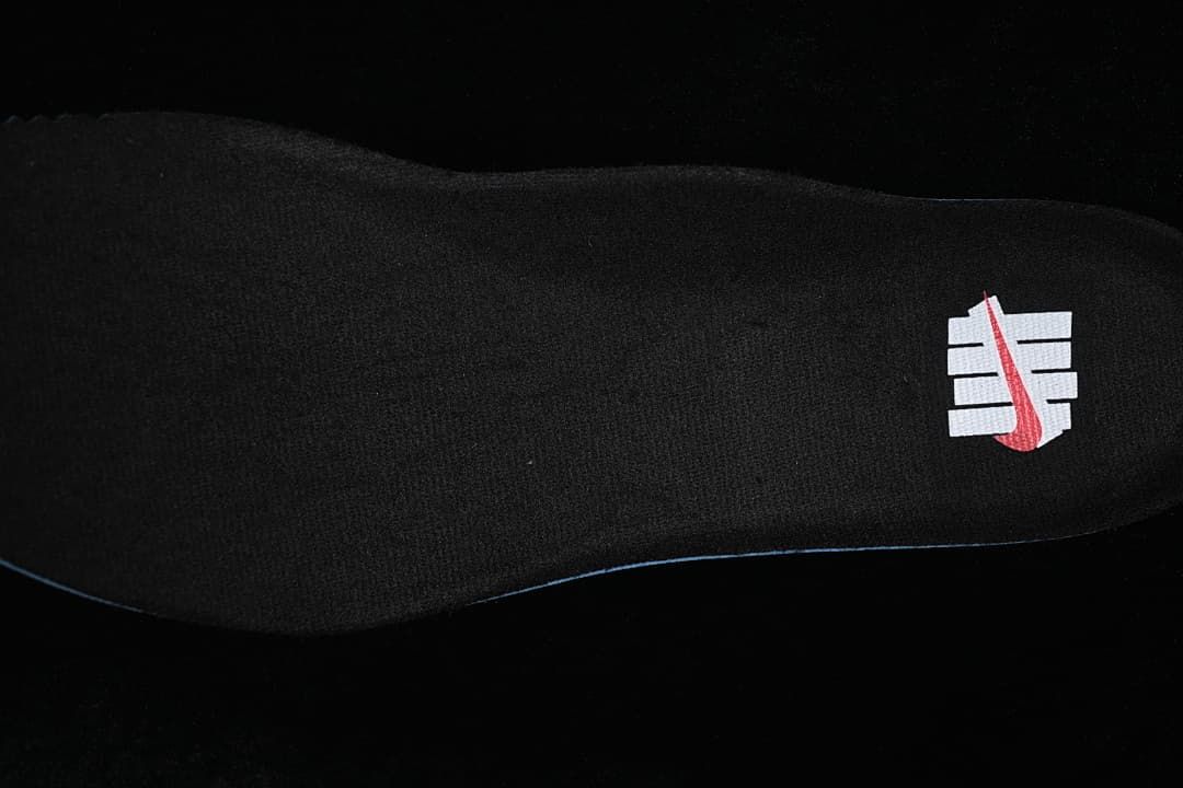 Black insole with a white-and-red logo graphic