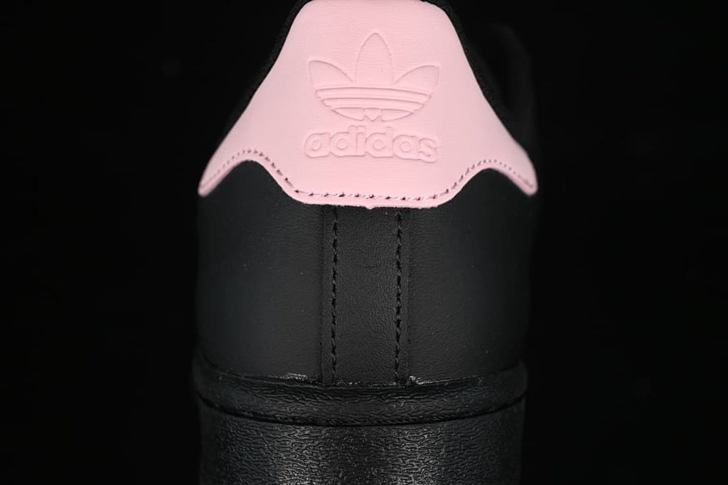 Rear view of the sneaker showing the pink heel tab and black heel