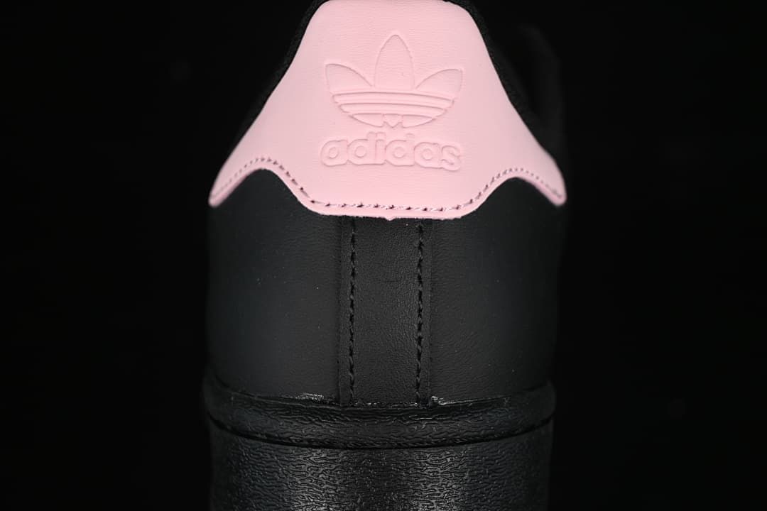 Rear view of the sneaker showing the pink heel tab and black heel