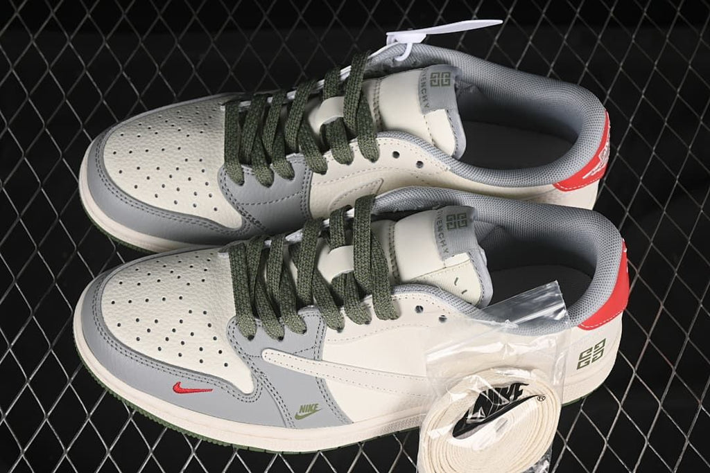 Pair of off-white and grey low-top sneakers with dark green laces, red heel accents, and an additional set of light laces