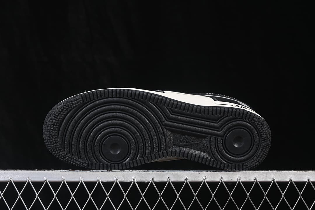 Underside view showing the black circular-patterned outsole.