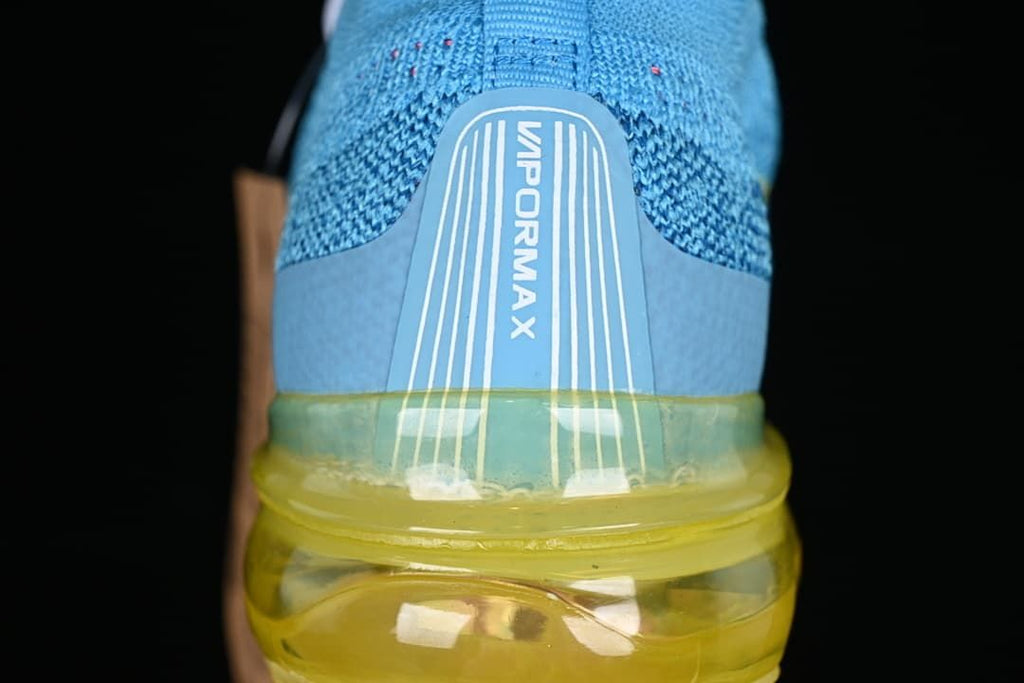 Rear close-up of the knit heel, VaporMax branding and translucent yellow sole.