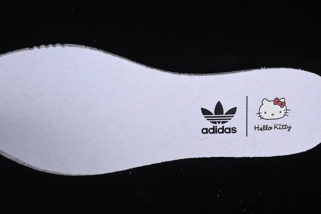 Close-up of an insole printed with adidas Trefoil and Hello Kitty branding.