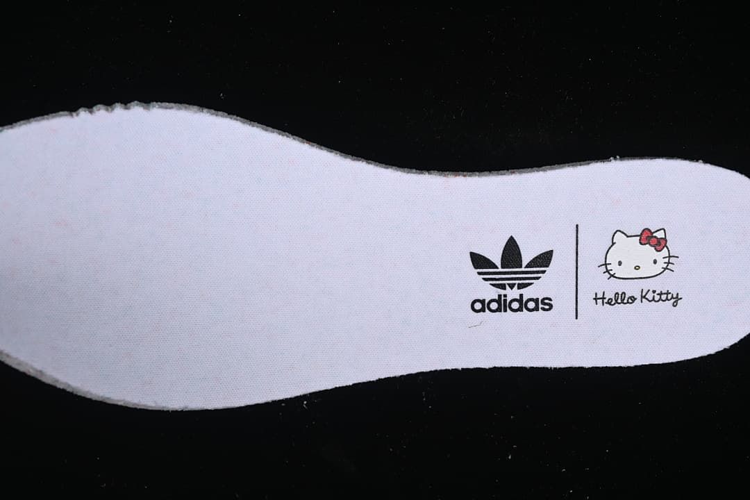 Close-up of an insole printed with adidas Trefoil and Hello Kitty branding.