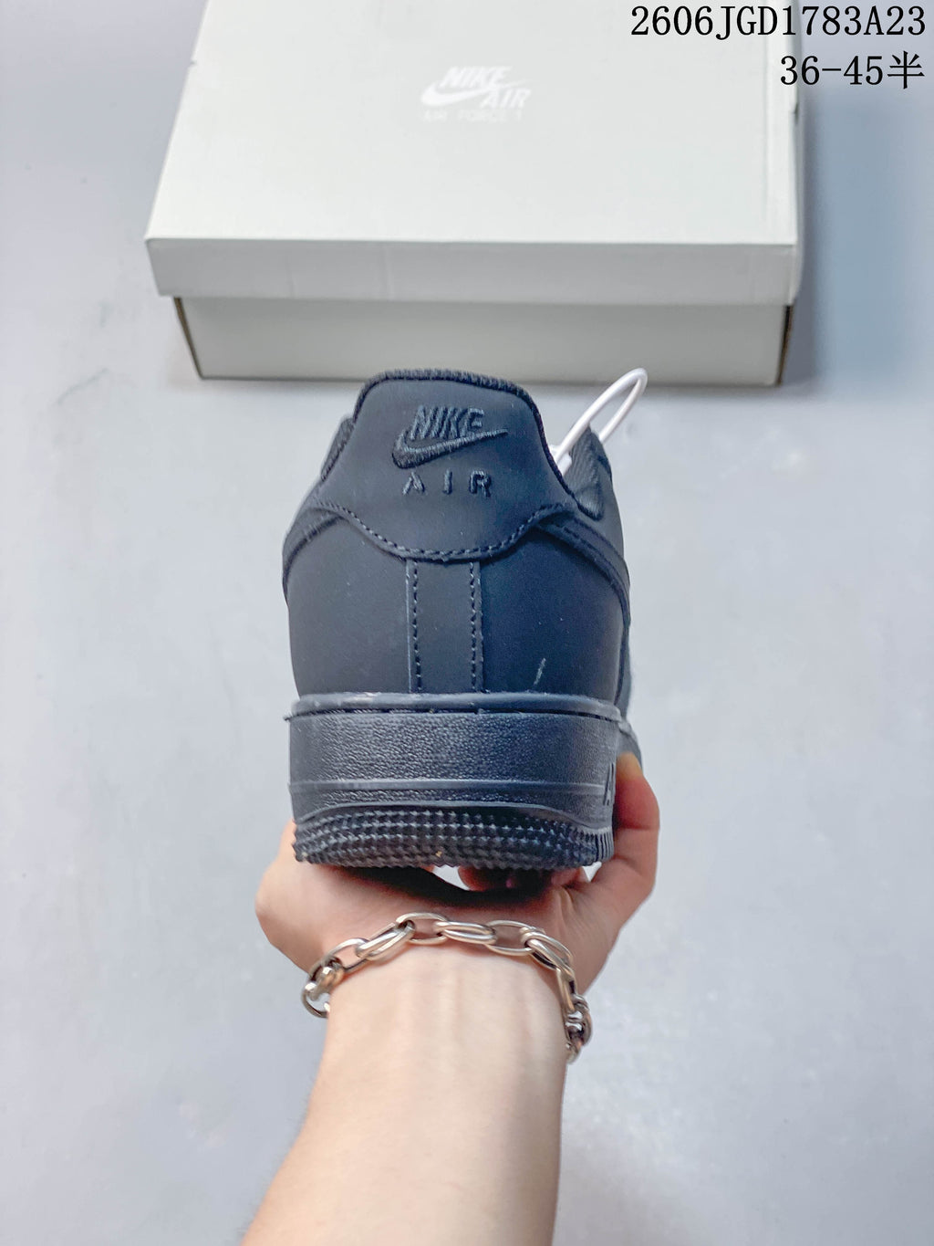 Rear view of a dark gray low-top sneaker with Nike Air branding.