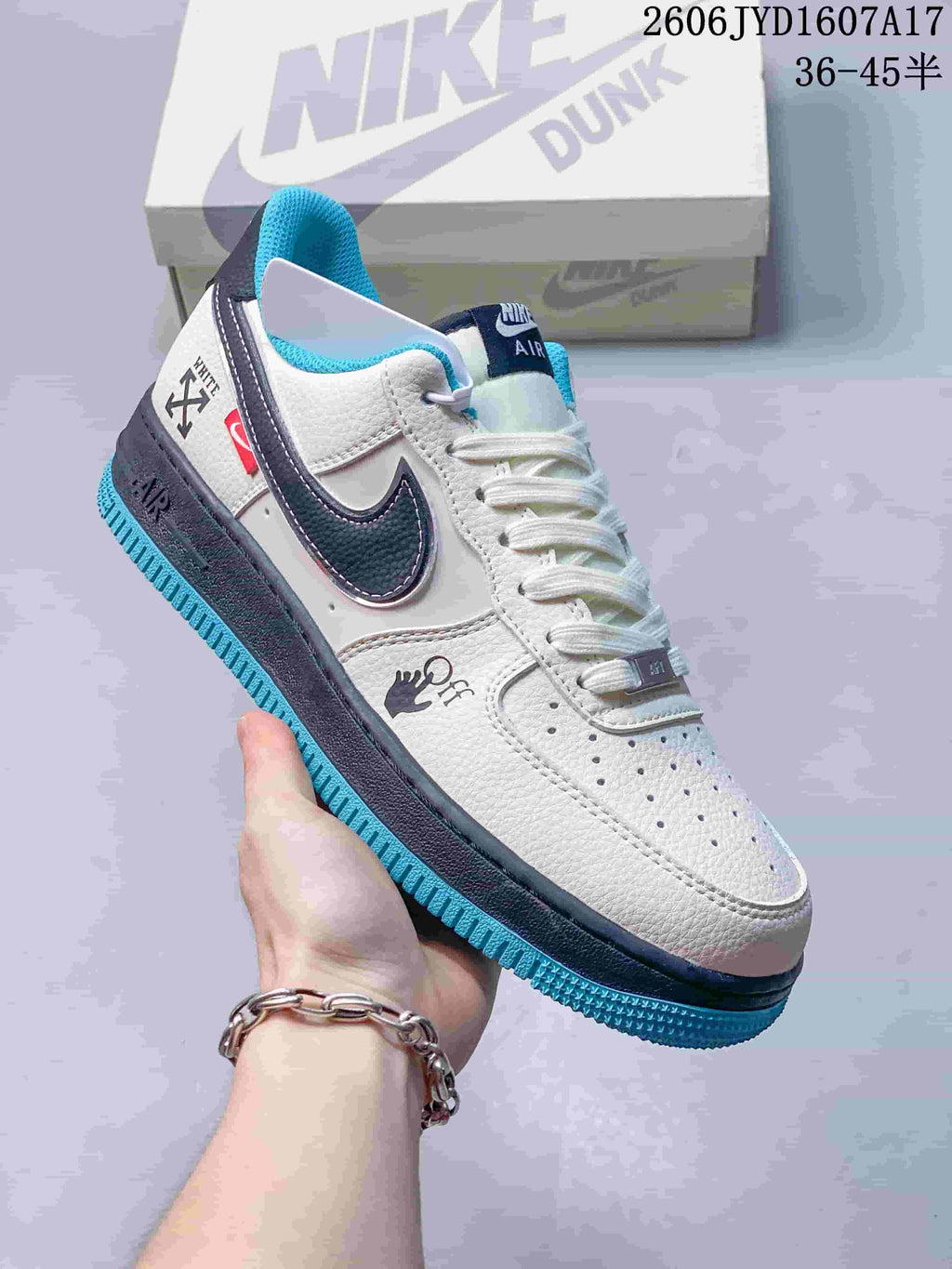 Angled side view showing graphic accents, navy Swoosh, and turquoise outsole