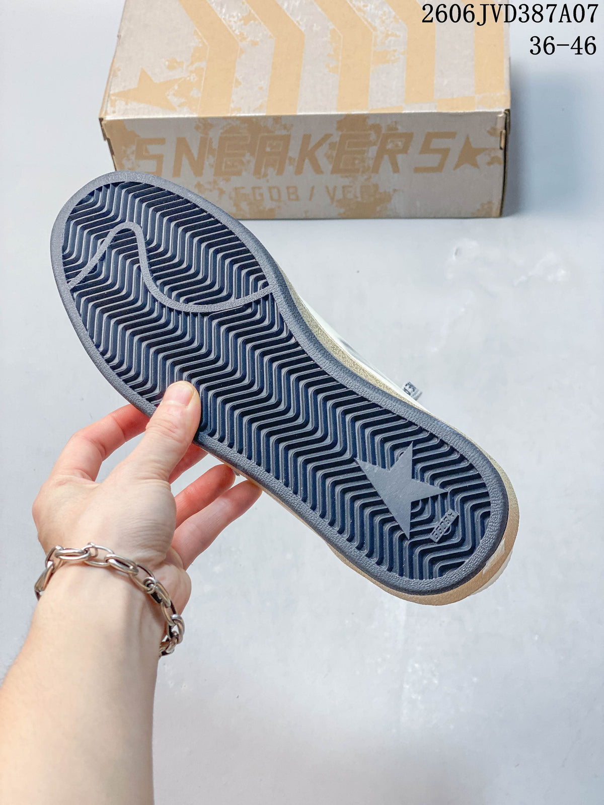 Underside of the sneaker showing a dark patterned outsole