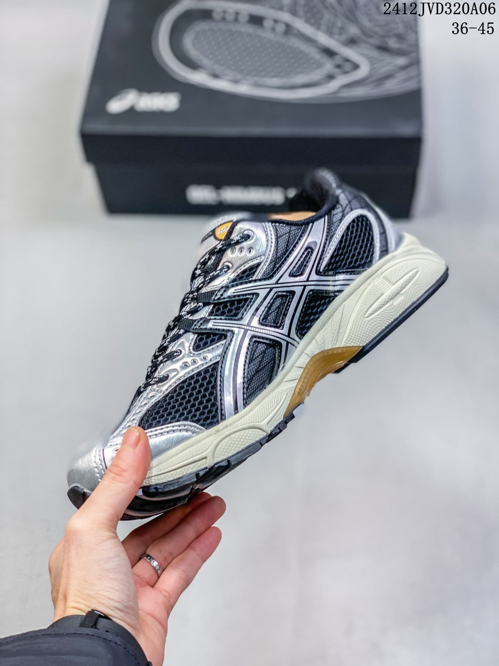 Side view of a silver and black ASICS Gel-Nimbus 10.1 sneaker with a cream midsole.