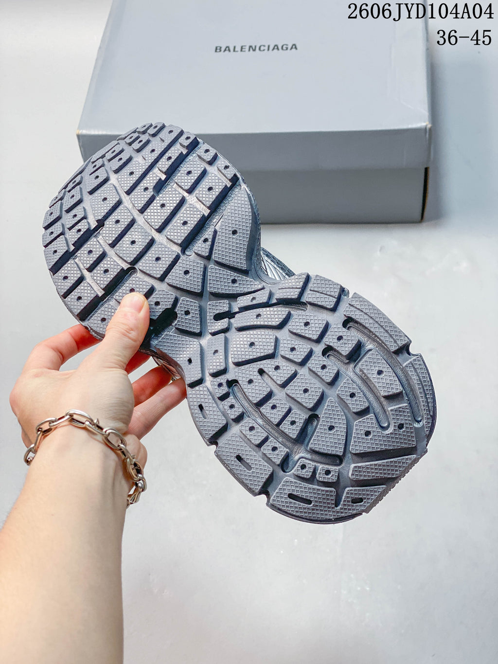 Outsole view of a metallic gray sneaker showing segmented tread; image overlay states sizes 36–45.