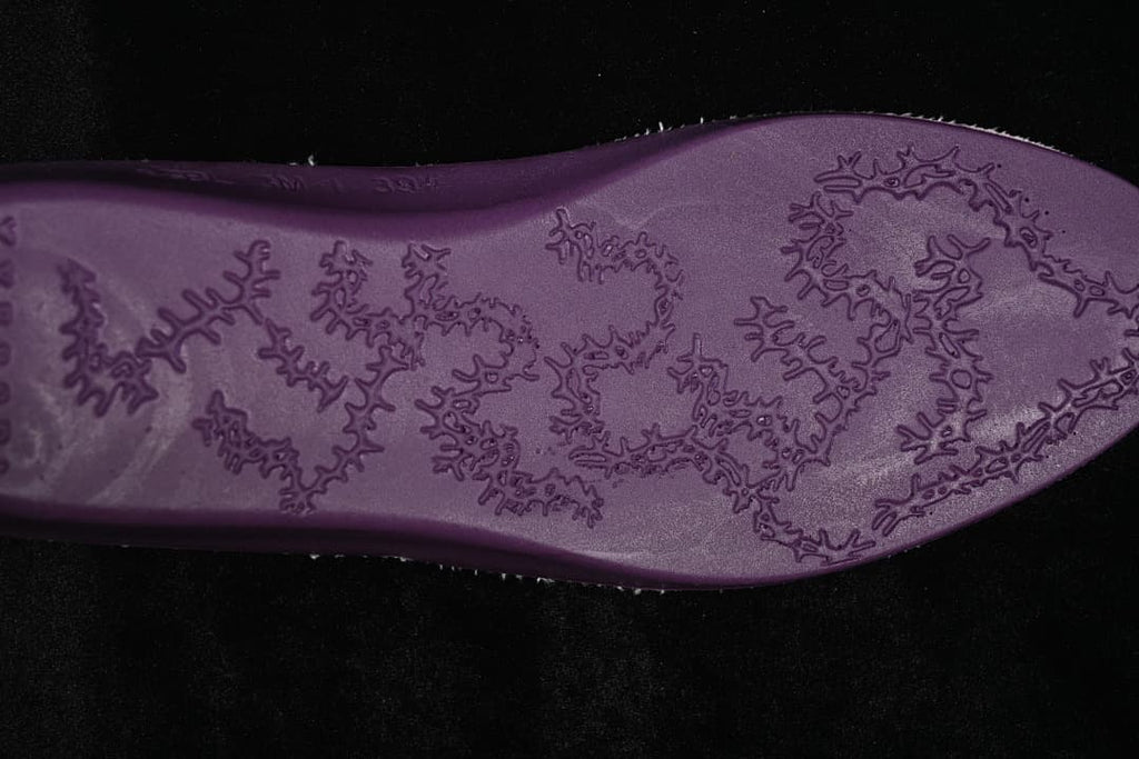 Close-up of the sneaker outsole with an irregular raised pattern