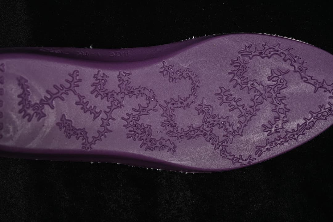 Close-up of the sneaker outsole with an irregular raised pattern
