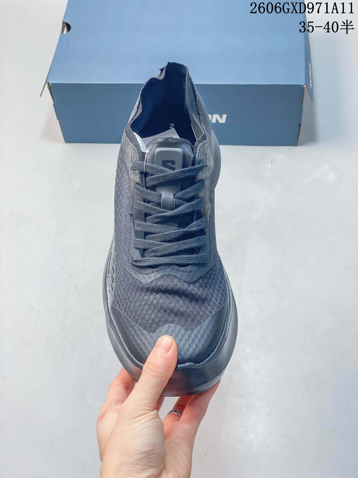 Front view of a gray Salomon sneaker showing the laces and textured upper