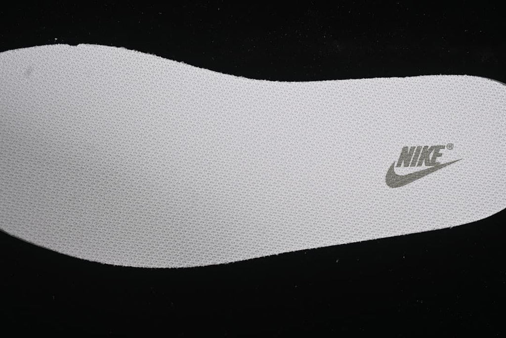 Close-up view of a light grey shoe insert with Nike branding