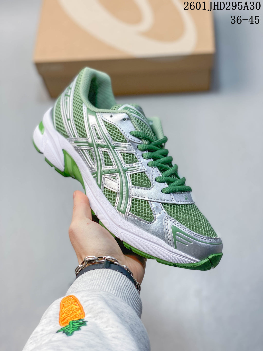 Angled side view of the green and silver ASICS GEL-NIMBUS 10.1 sneaker.
