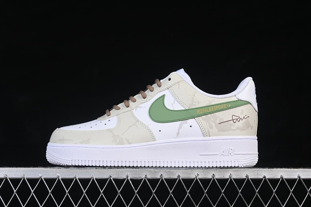 Side view of a white and cream Nike Air Force 1 '07 Low with a green side accent and brown laces
