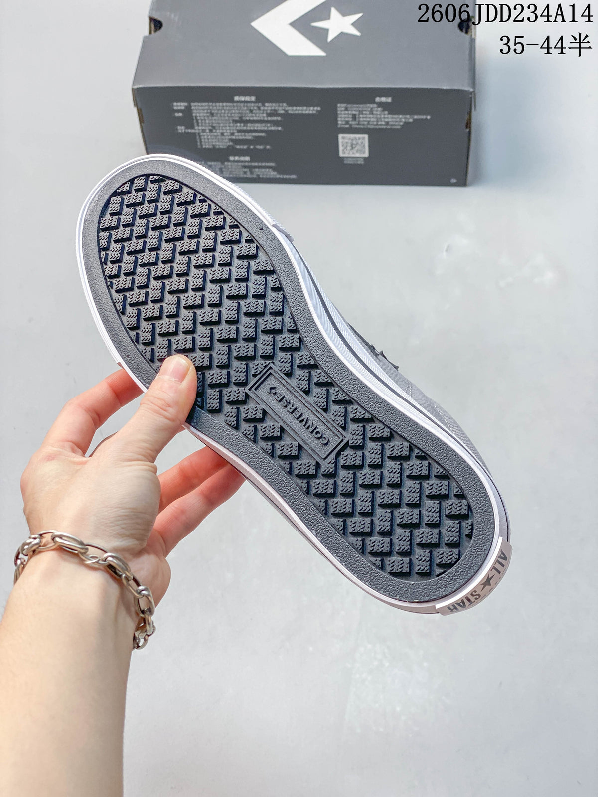 Close-up of the patterned outsole on the gray sneakers