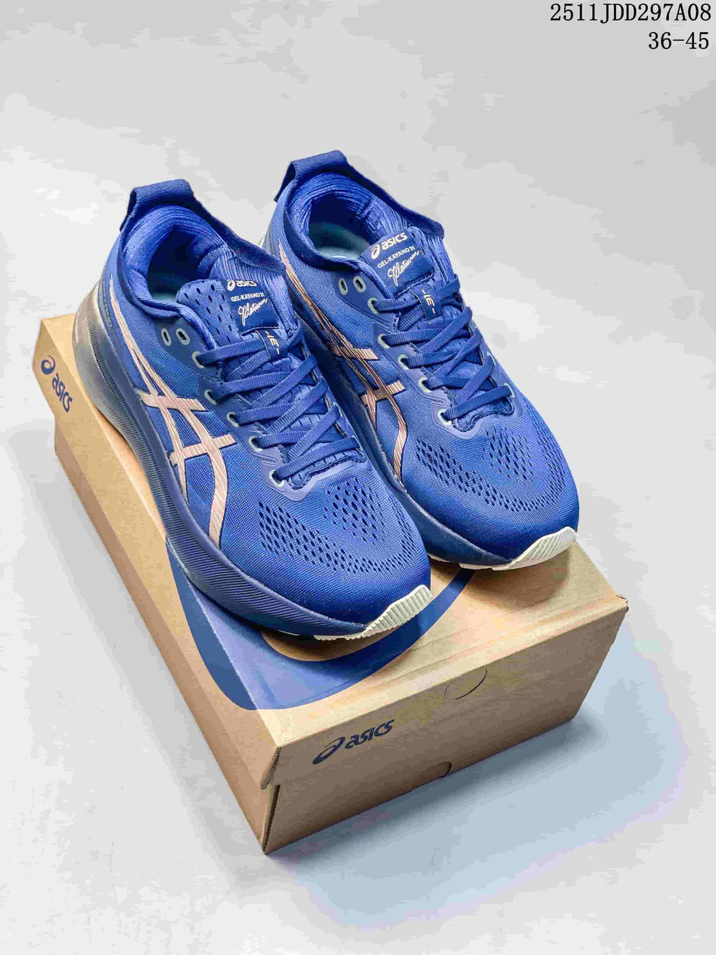 Blue ASICS GEL-KAYANO 31 shoes with gold-tone side stripes shown on a shoebox