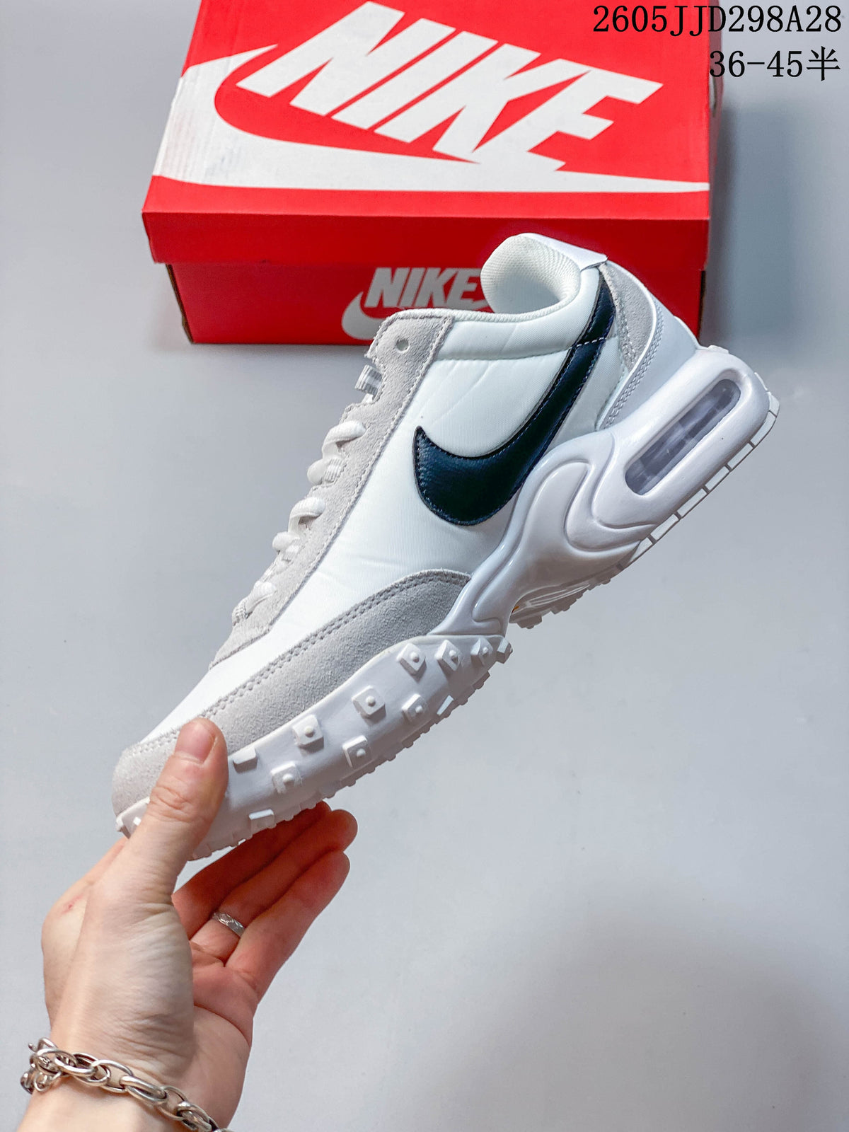 Side view of the white and light grey Nike Air Max Waffle SP with dark Swoosh and heel Air unit