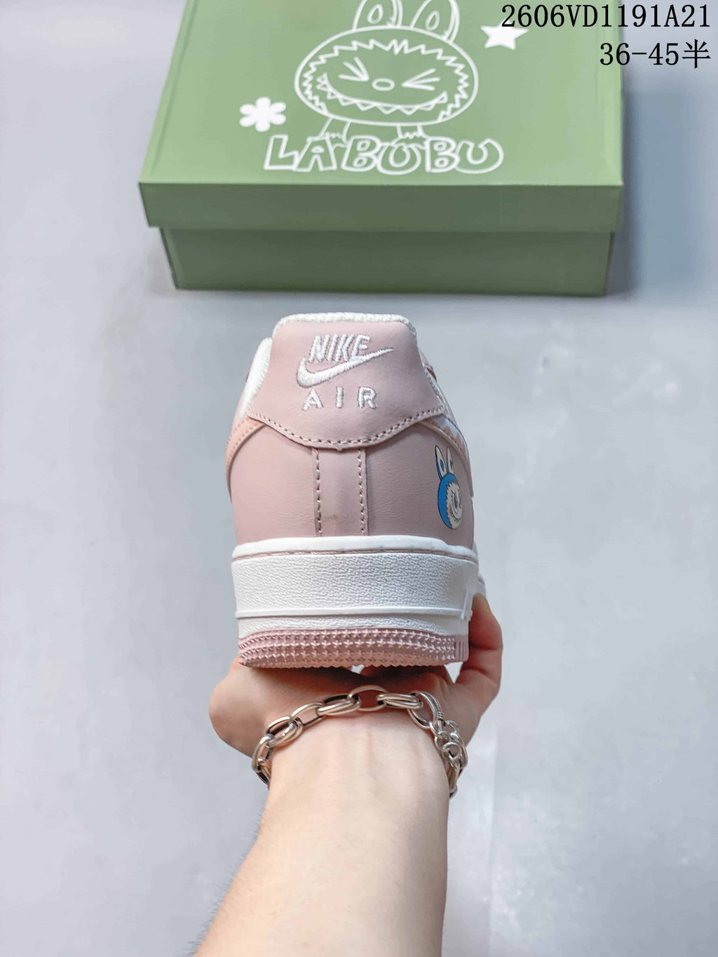 Rear view of the pink and white sneaker with a character graphic