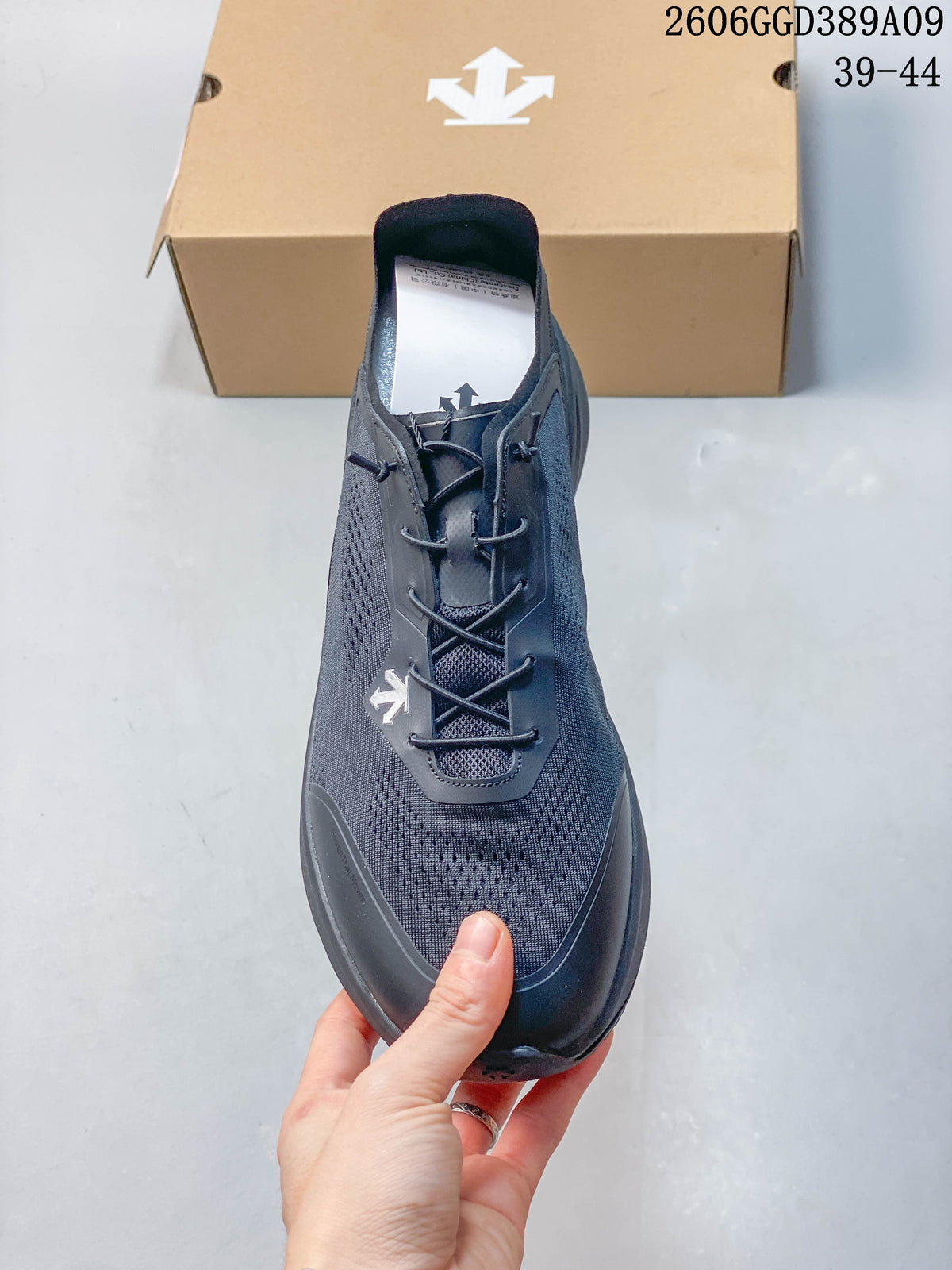 Top view of a dark gray Descente running shoe showing the lace adjustment system.