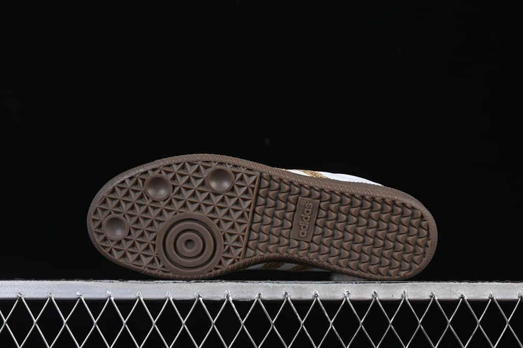 Underside of the sneaker showing the patterned gum-colored outsole