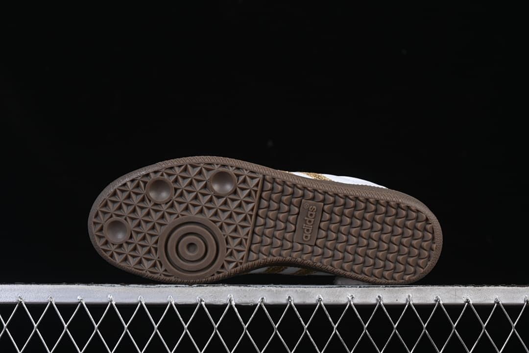 Underside of the sneaker showing the patterned gum-colored outsole