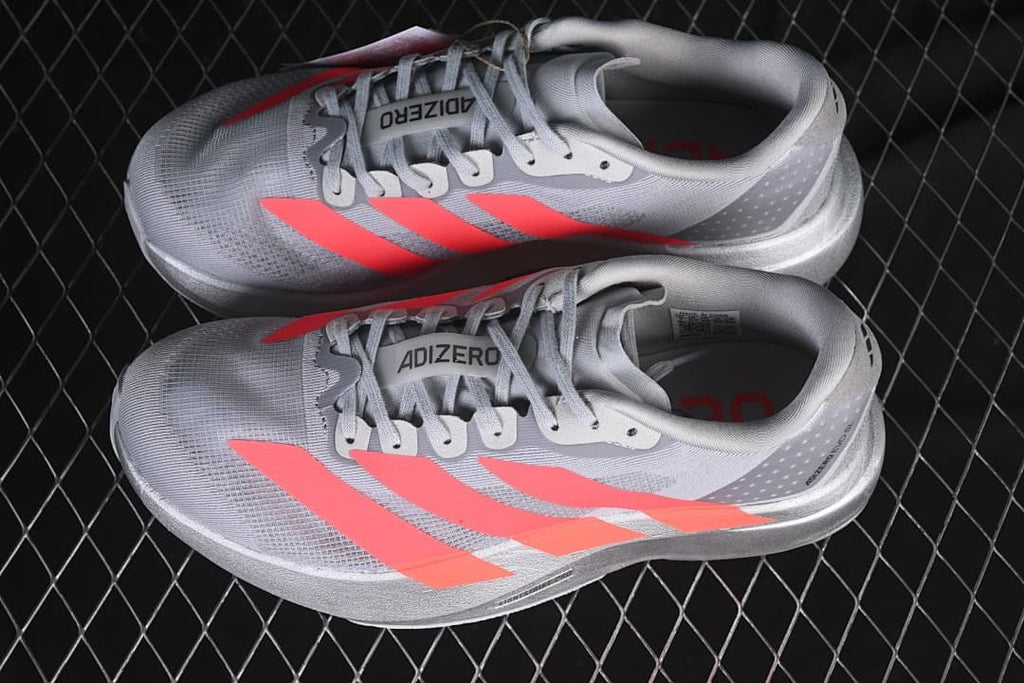Pair of gray and coral Adizero Evo SL running shoes viewed from above