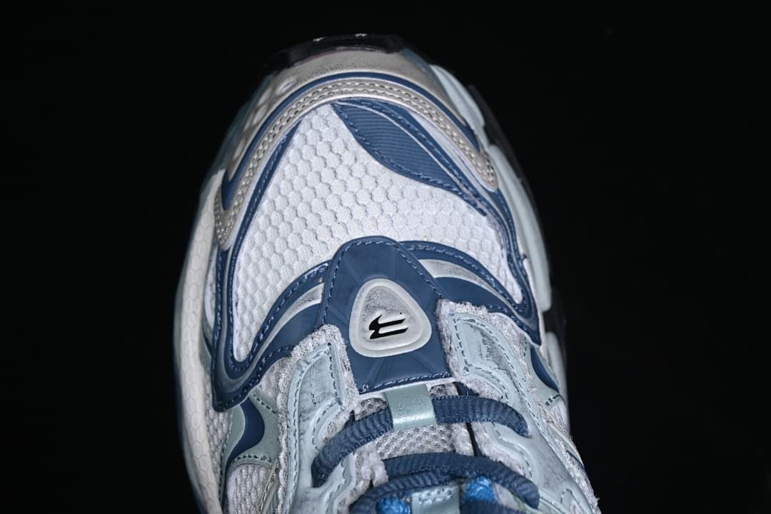 Top-down close-up of the sneaker toe and layered front overlays