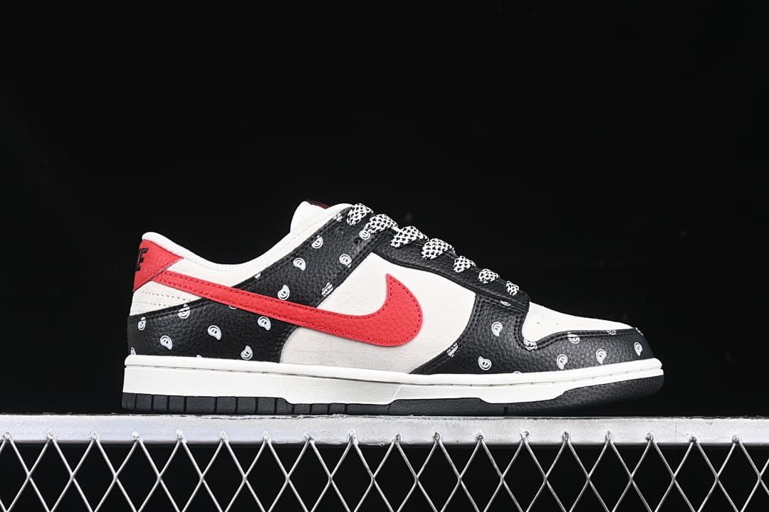 Side profile of a low-top sneaker with a red Swoosh and paisley-patterned black overlays.
