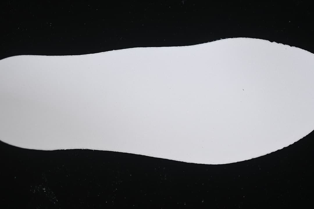 White shoe-shaped insert shown against a black background