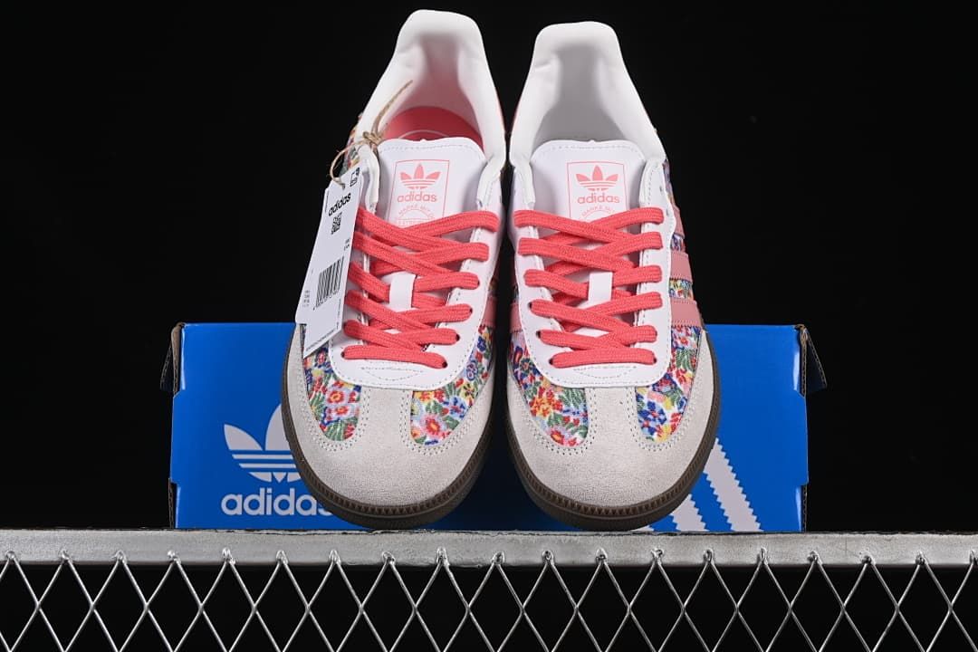 Front view of the pair with floral-print panels, pink laces, and light-colored toe overlays