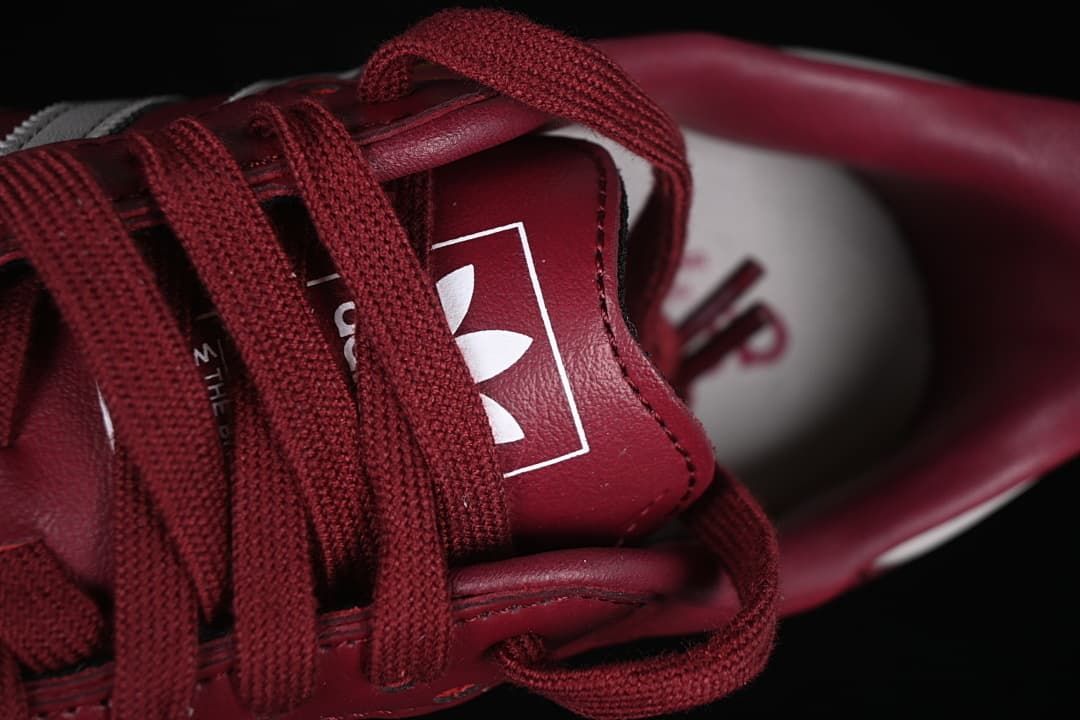 Close-up of the tongue branding and burgundy laces