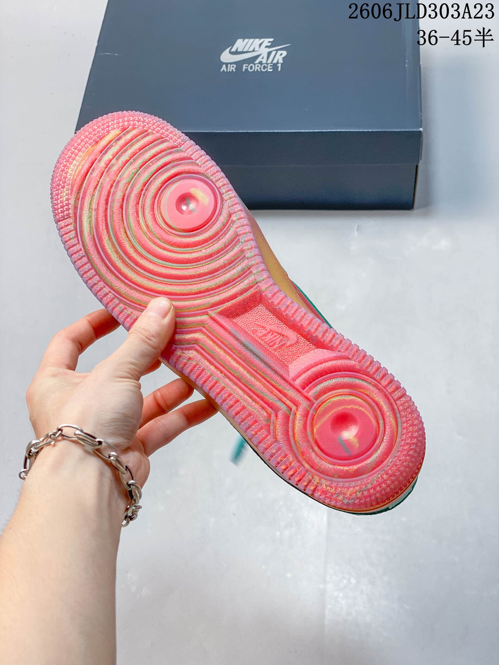 Close-up of the multicolor circular-pattern outsole on a Nike Air Force 1 sneaker