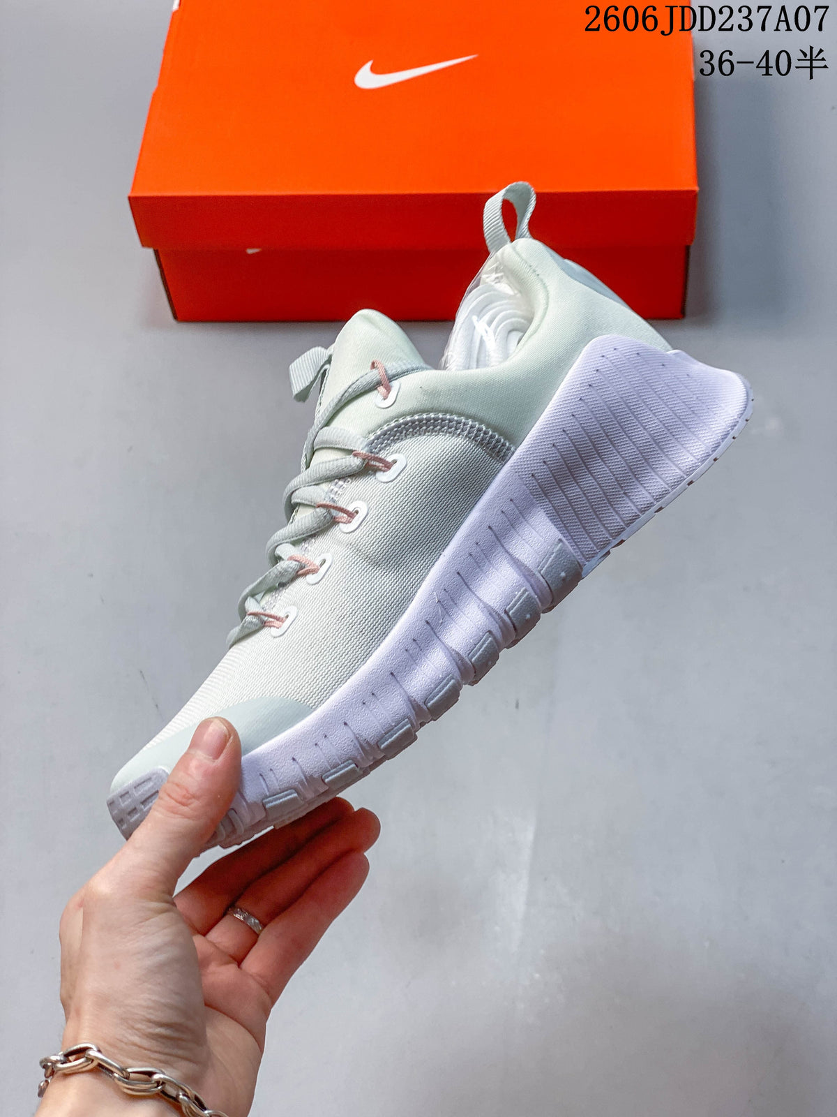 Side view of a pale mint Nike Free Metcon 6 shoe with a sculpted white sole