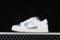 Side view of a white and silver Nike SB Dunk Low sneaker