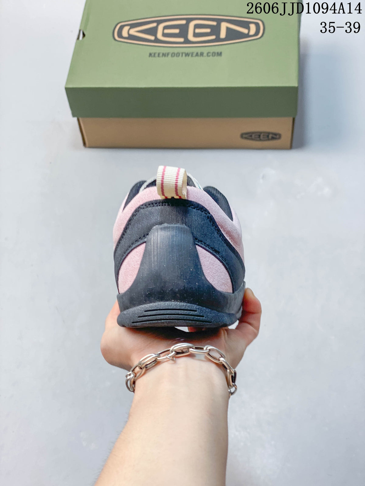 Rear view of the pink sneaker with dark navy heel detailing