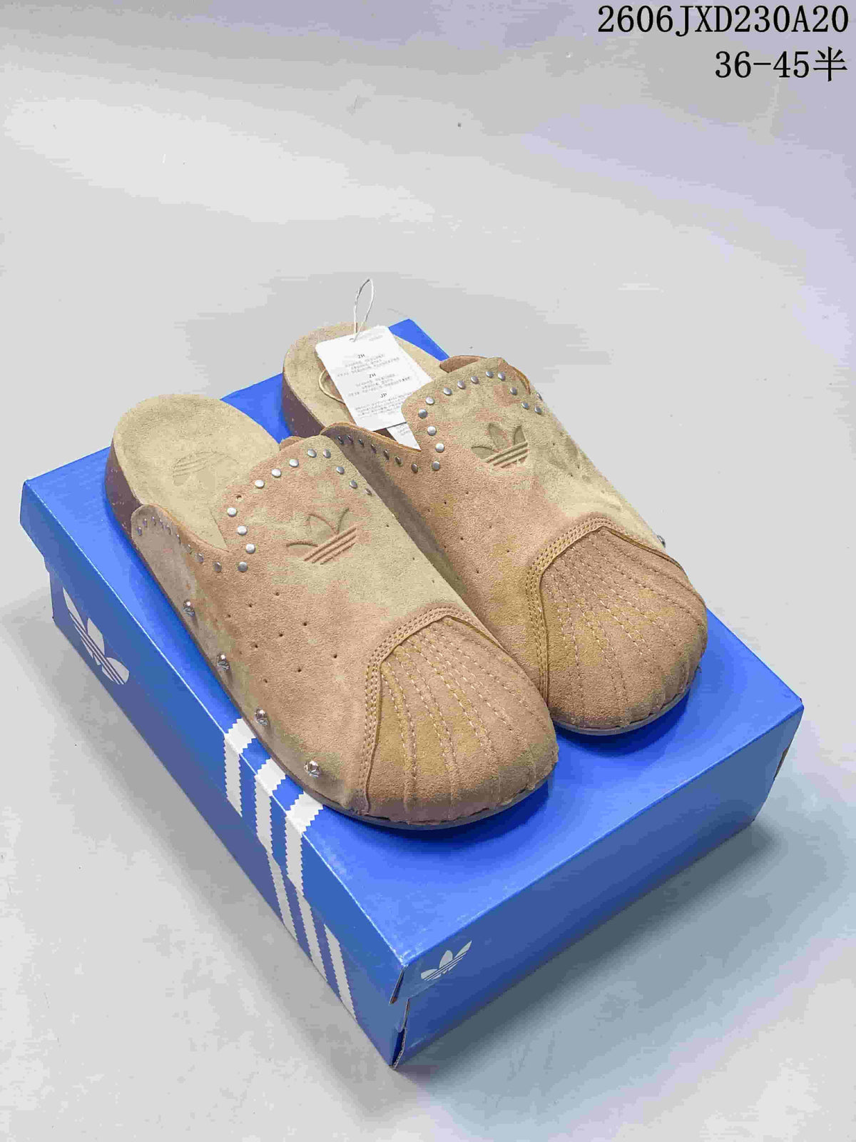 Pair of tan adidas Adimule closed-toe mule slides with decorative studs