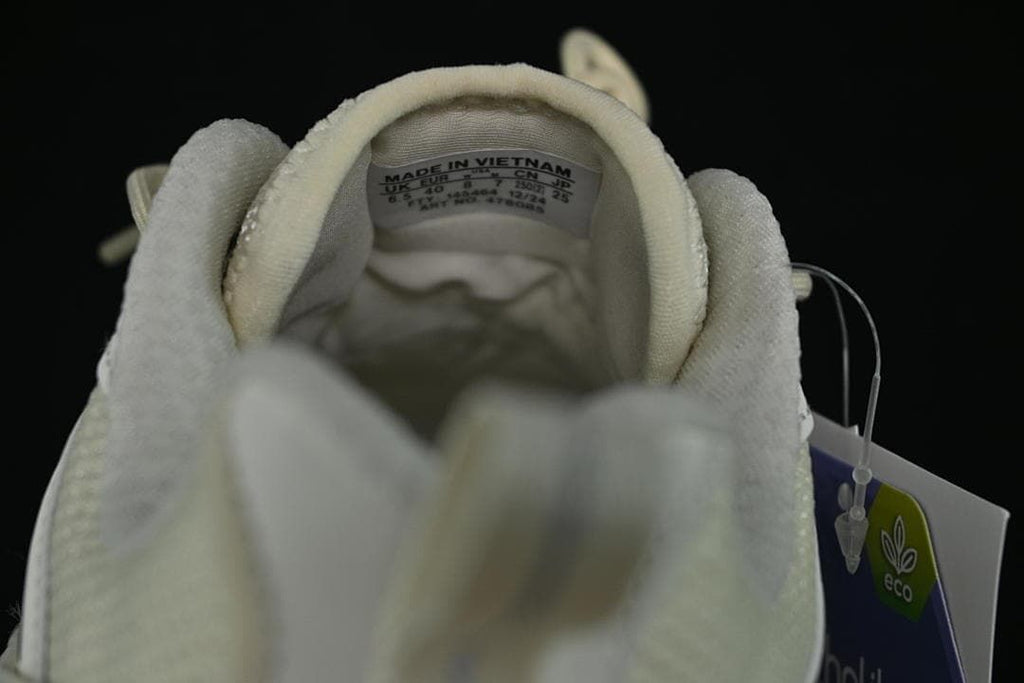 View into the shoe collar showing the size label and attached hangtag.