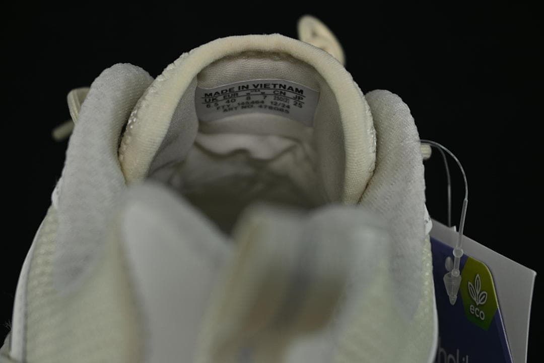 View into the shoe collar showing the size label and attached hangtag.