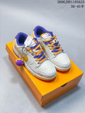 Pair of white Nike SB Dunk Low sneakers with gold and purple accents, contrasting laces, basketball charm, and orange Lakers-branded box