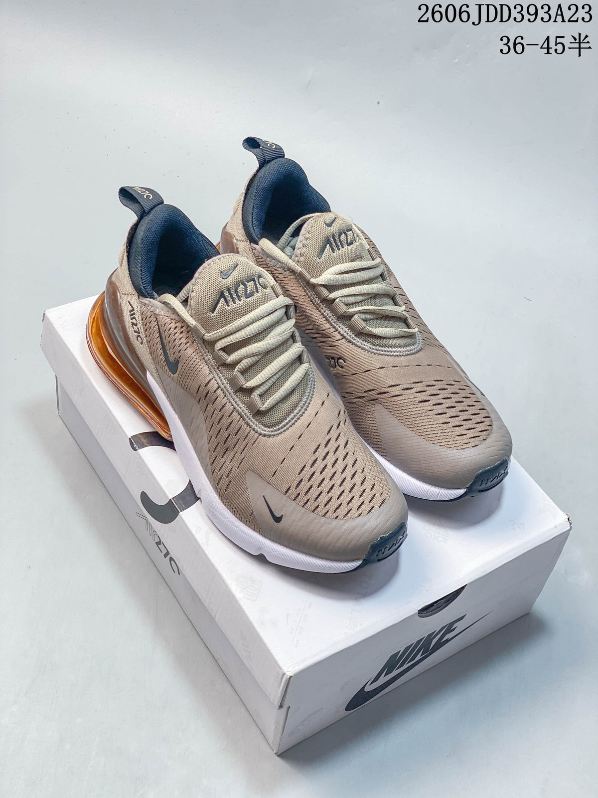 Pair of beige and grey-toned Nike Air Max 270 sneakers on a box, viewed from above and at an angle.