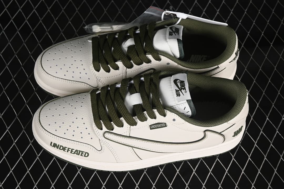 Overhead view of a pair of off-white and olive low-top sneakers with contrast laces