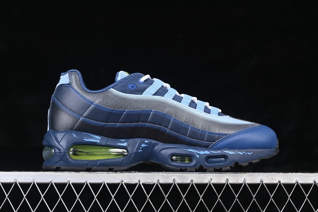 Side profile of the blue sneaker with green-accented Air units