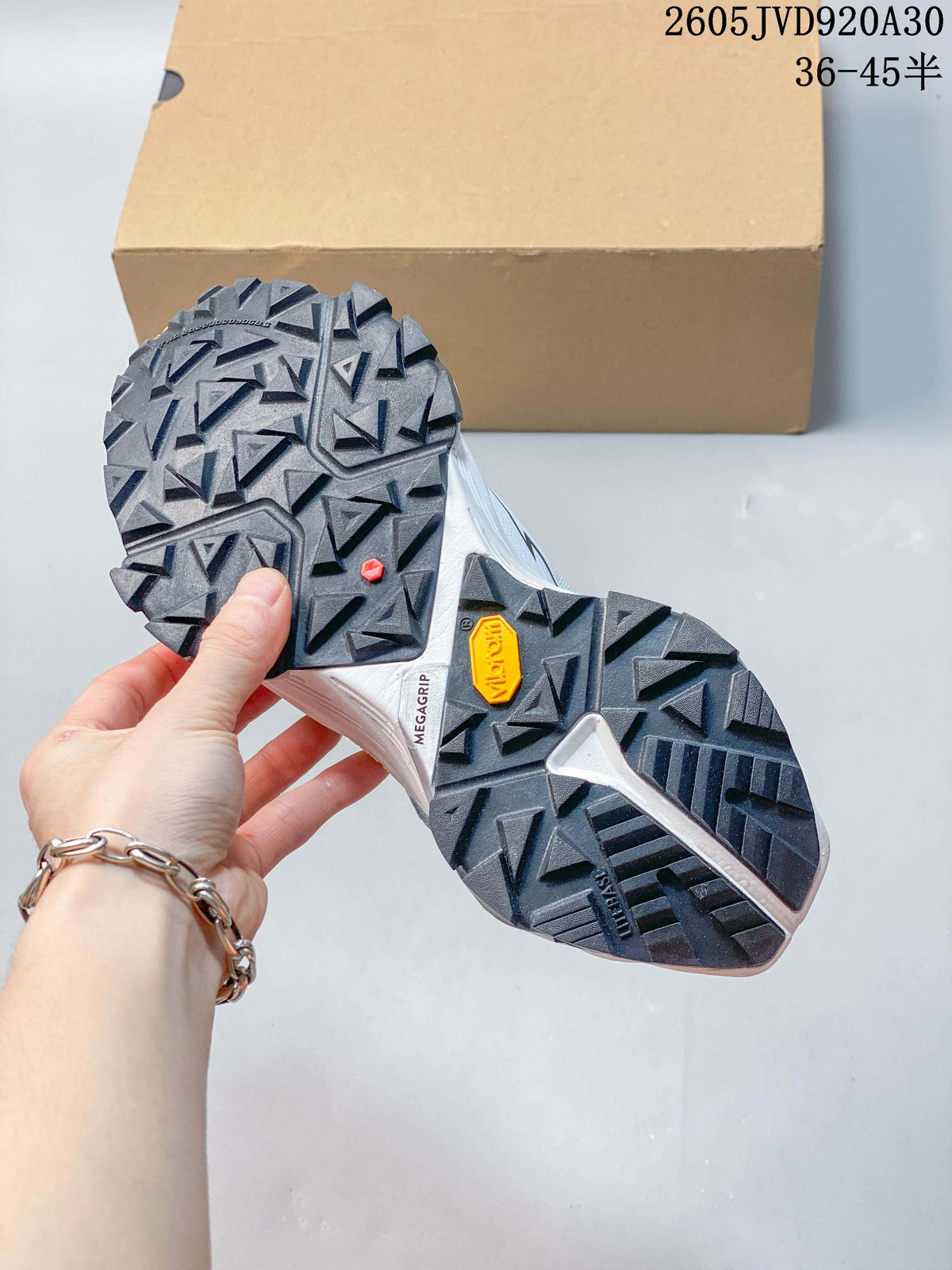 Close-up of the trail shoes' lugged outsole, including a visible Vibram Megagrip mark.